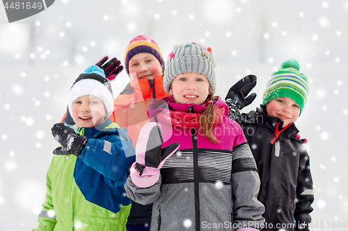 Image of happy little kids in winter clothes outdoors