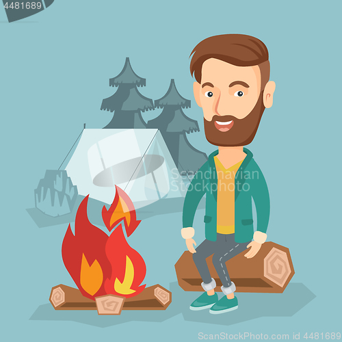 Image of Man sitting on log near campfire in the camping.