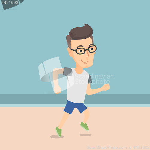 Image of Caucasian sporty man jogging on the beach.