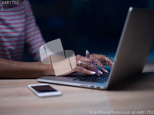 Image of black businesswoman using a laptop in startup office