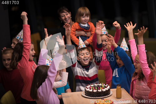 Image of The young boy joyfully celebrating his birthday