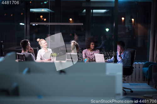 Image of Multiethnic startup business team in night office