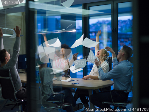 Image of multiethnic Group of young business people throwing documents