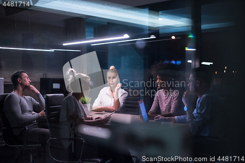 Image of Multiethnic startup business team in night office