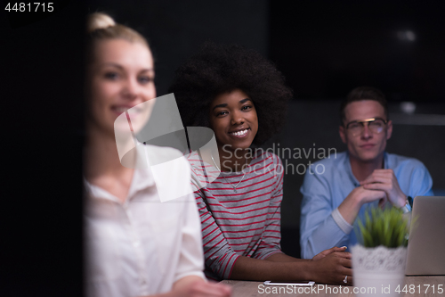 Image of Multiethnic startup business team in night office