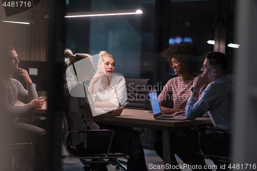 Image of Multiethnic startup business team in night office