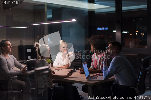 Image of Multiethnic startup business team in night office