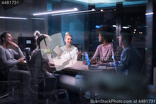 Image of Multiethnic startup business team in night office