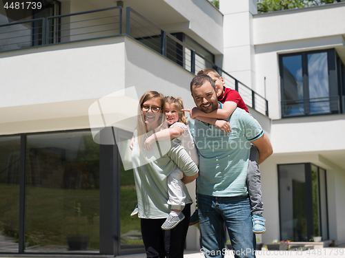 Image of happy family with children in the yard