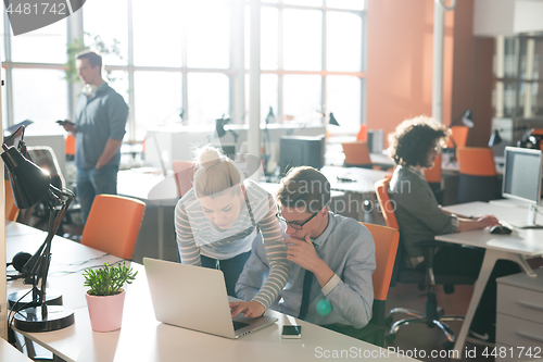 Image of Two Business People Working With laptop in office