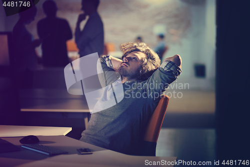 Image of businessman relaxing at the desk