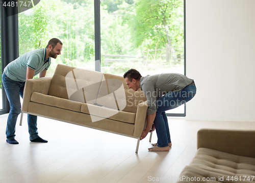 Image of men carry the sofa