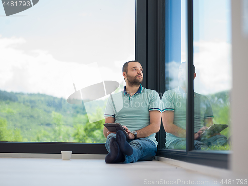 Image of man on the floor enjoying relaxing lifestyle