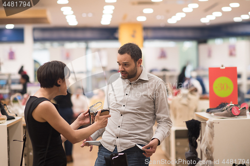 Image of couple chooses shoes At Shoe Store