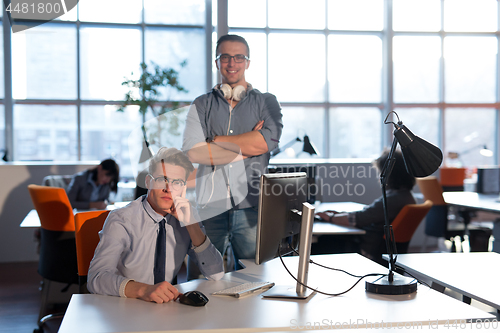 Image of Two Business People Working With computer in office