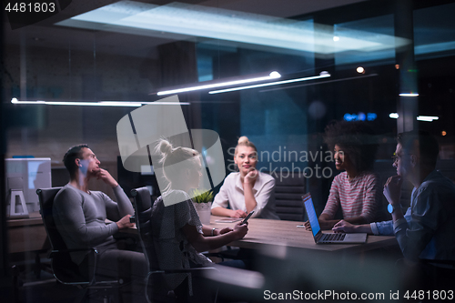 Image of Multiethnic startup business team in night office