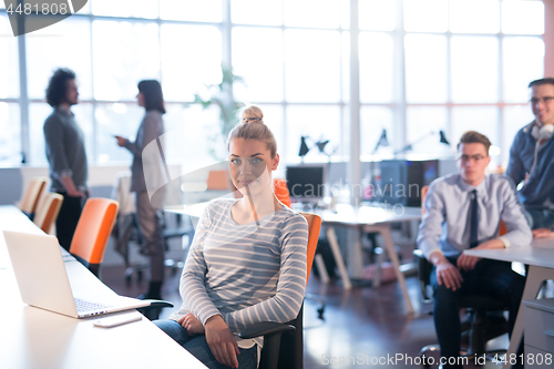 Image of businesswoman using a laptop in startup office