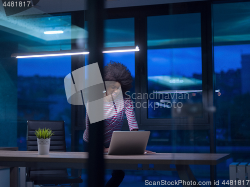 Image of black businesswoman using a laptop in startup office