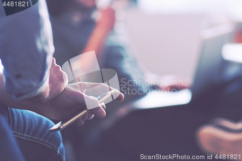 Image of Young man holding smartphone