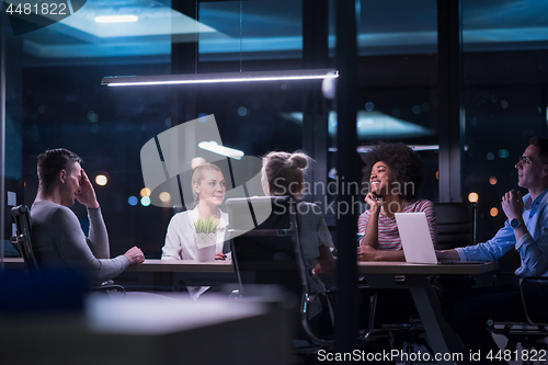 Image of Multiethnic startup business team in night office