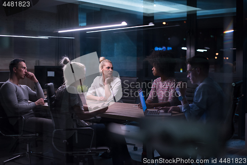 Image of Multiethnic startup business team in night office