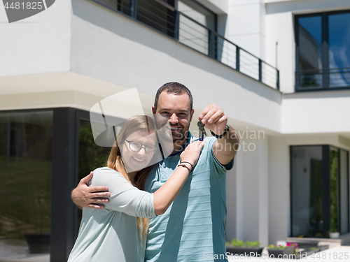 Image of couple hugging in front of  new luxury home