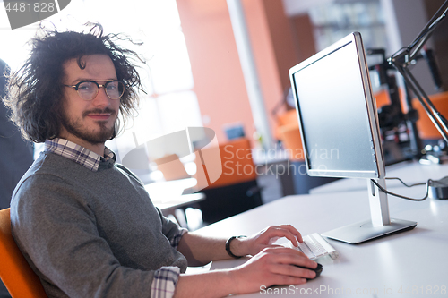 Image of businessman working using a computer in startup office