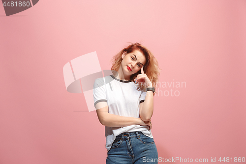 Image of Let me think. Doubtful pensive woman with thoughtful expression making choice against pink background