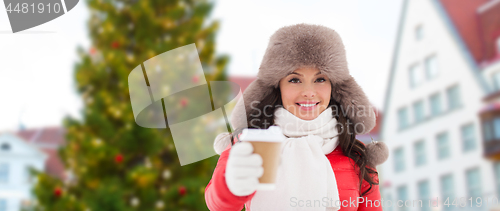 Image of woman with coffee over christmas tree in tallinn