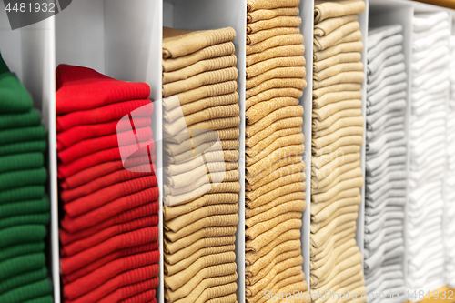 Image of close up of shelves with clothes at clothing store