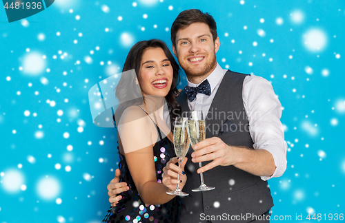 Image of happy couple with champagne celebrating christmas