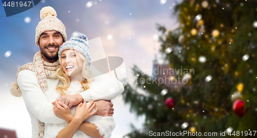 Image of happy couple hugging over christmas tree