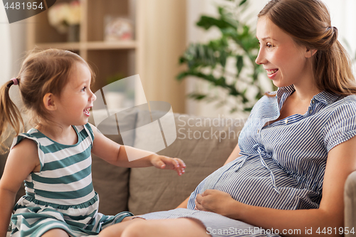 Image of pregnant mother and daughter at home