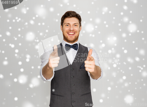 Image of happy man in festive suit pointing to you