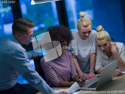 Image of Multiethnic startup business team in night office