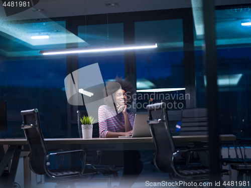 Image of black businesswoman using a laptop in startup office