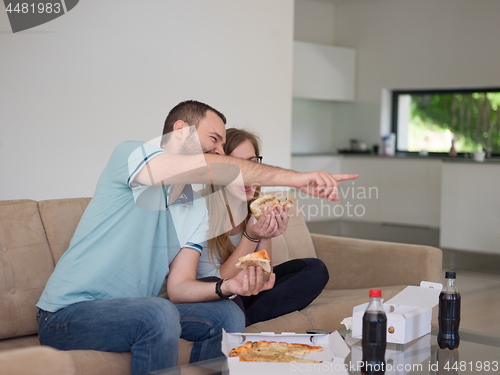Image of couple eating pizza in their luxury home villa