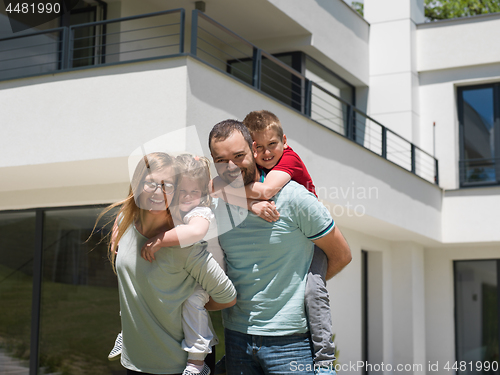 Image of happy family with children in the yard