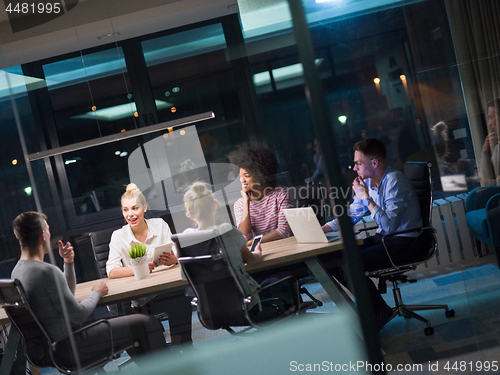 Image of Multiethnic startup business team in night office