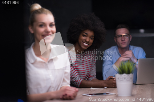 Image of Multiethnic startup business team in night office