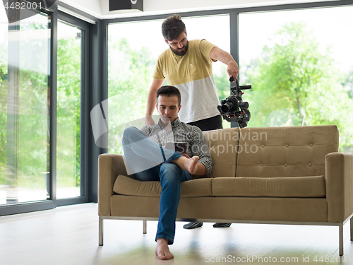 Image of man on sofa using tablet computer