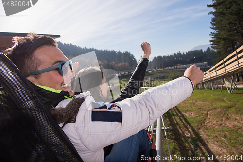 Image of couple enjoys driving on alpine coaster