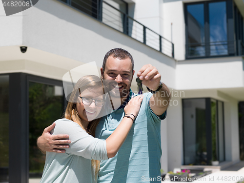 Image of couple hugging in front of  new luxury home