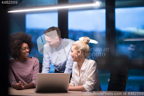 Image of Multiethnic startup business team in night office