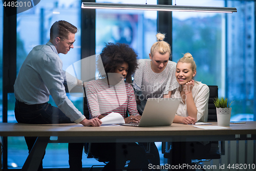 Image of Multiethnic startup business team in night office