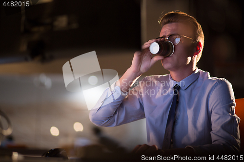 Image of Tired businessman working late