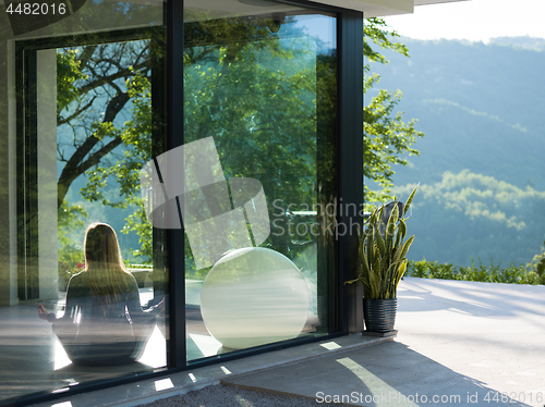 Image of young woman doing morning yoga exercises