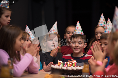 Image of The young boy joyfully celebrating his birthday