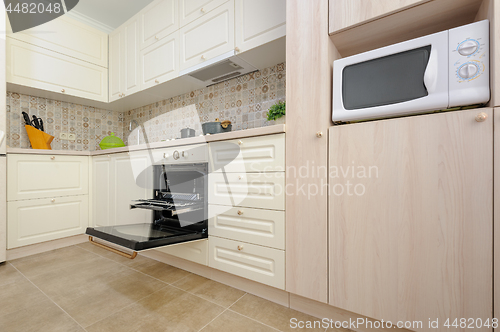 Image of Modern beige colored kitchen