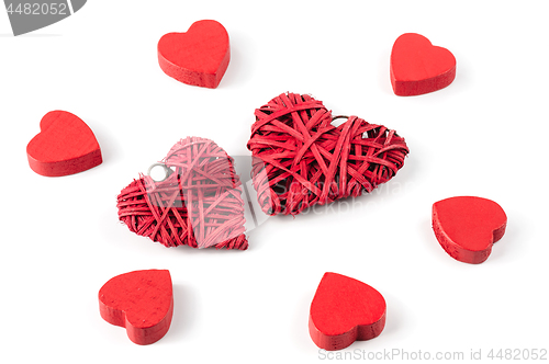 Image of Group or red hearts isolated on white, six wooden and two strawy